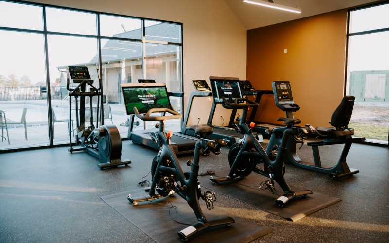 room with fitness equipment and large windows