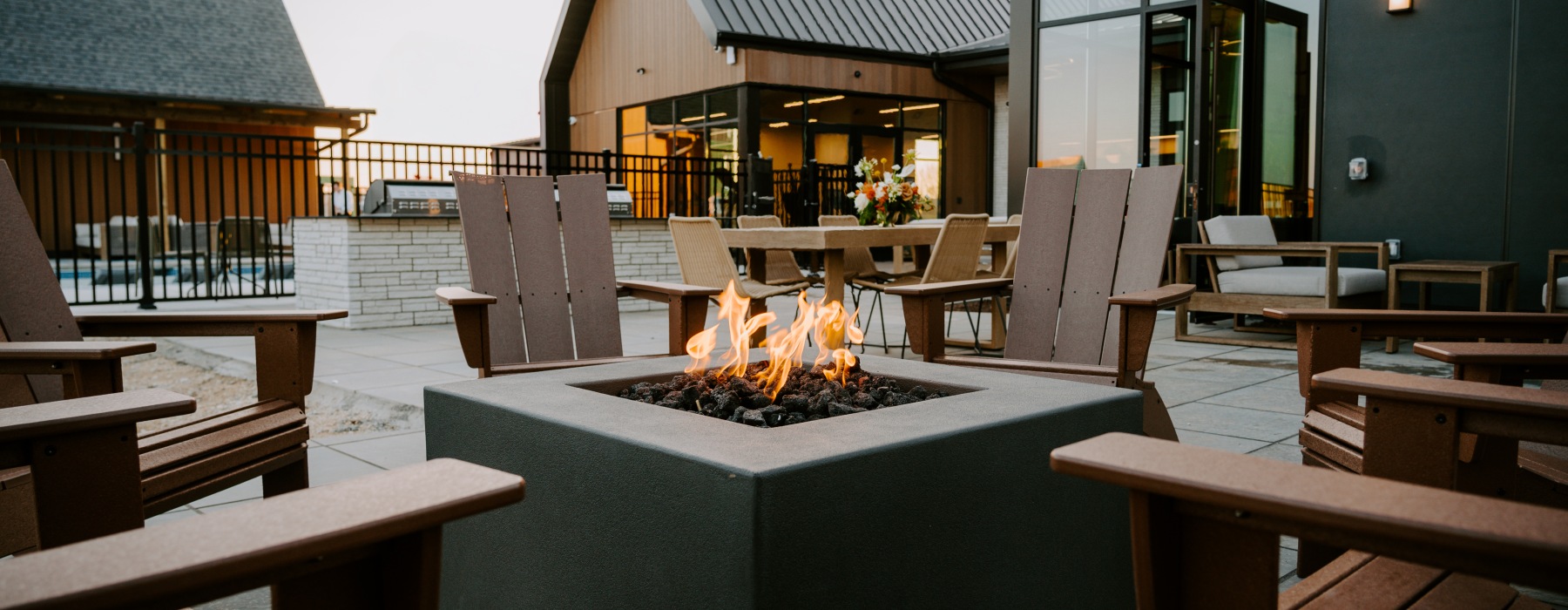 fire burning in a fire pit surrounded by chairs