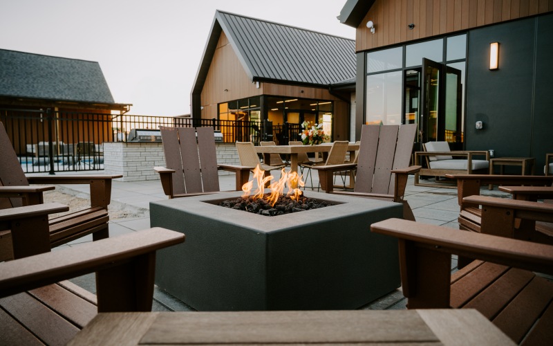 fire burning in a fire pit surrounded by chairs