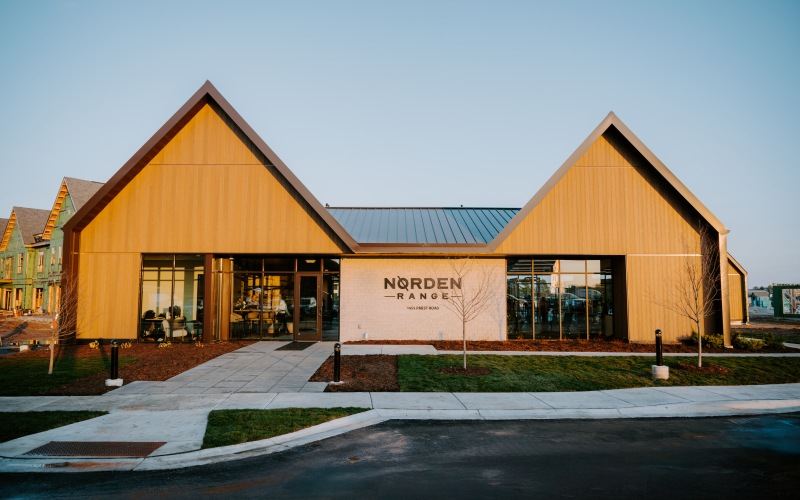 exterior of white and brown clubhouse at dusk