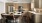 a dog sitting  near a table in a kitchen