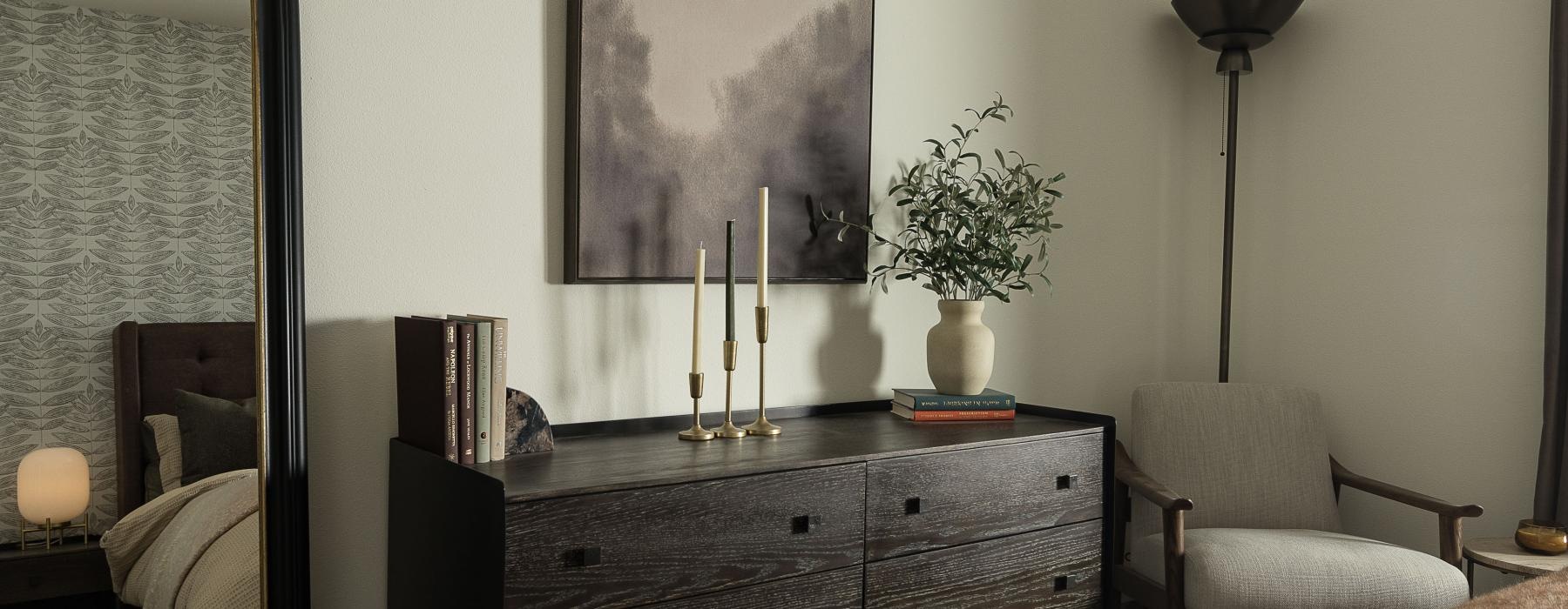 a bedroom with a dresser and a mirror