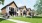 a group of people walking outside of a house